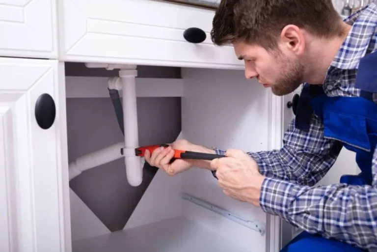 plumber repairing the bathroom sink plumbing in a residential property in aurora